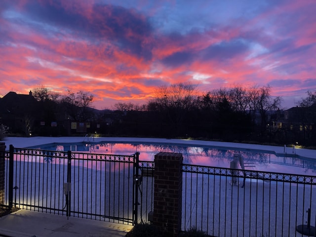 view of pool at dusk