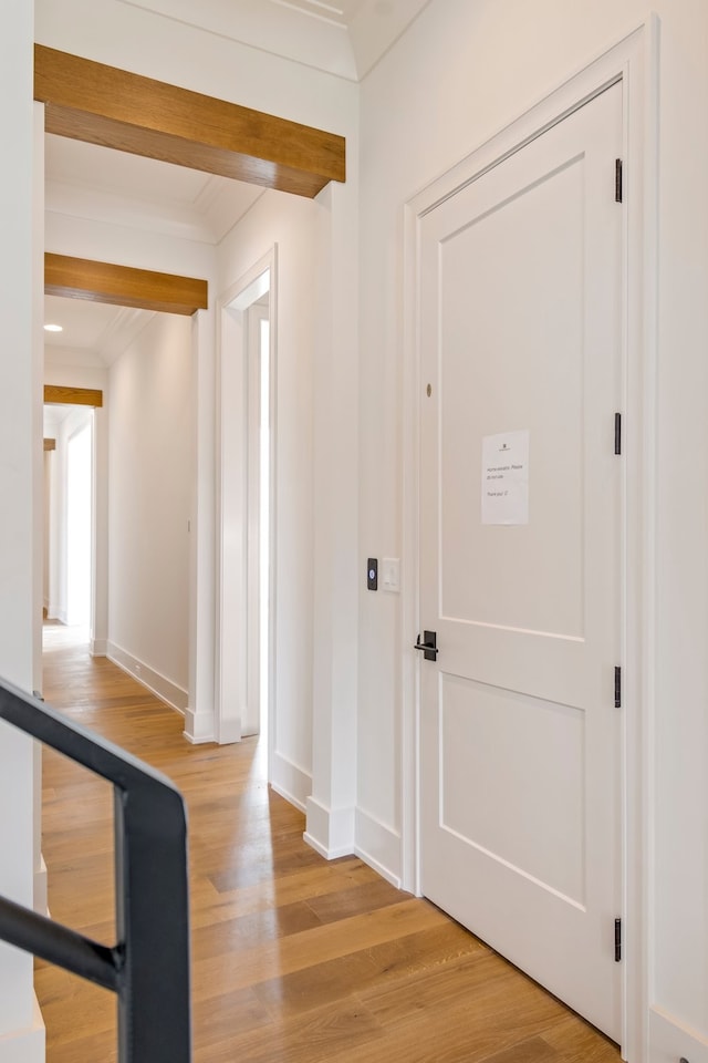 foyer with ornamental molding and light hardwood / wood-style flooring