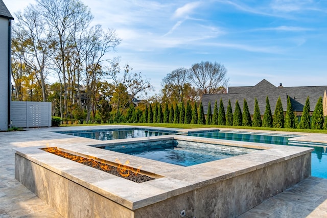 view of pool featuring an in ground hot tub