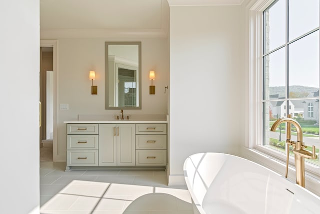 bathroom featuring plenty of natural light, a bathing tub, a mountain view, and tile patterned flooring