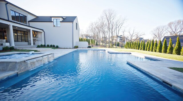 view of swimming pool with an in ground hot tub and a patio area