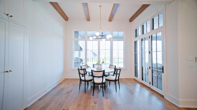 dining area featuring a notable chandelier, beam ceiling, french doors, and light wood-type flooring