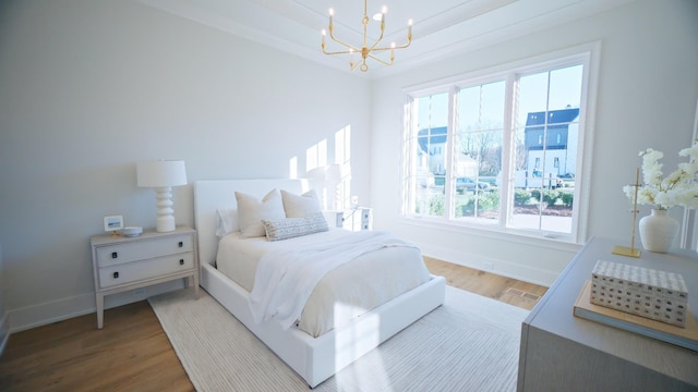 bedroom with a notable chandelier and wood-type flooring