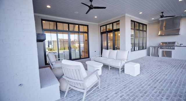 view of patio featuring area for grilling, outdoor lounge area, ceiling fan, and an outdoor kitchen