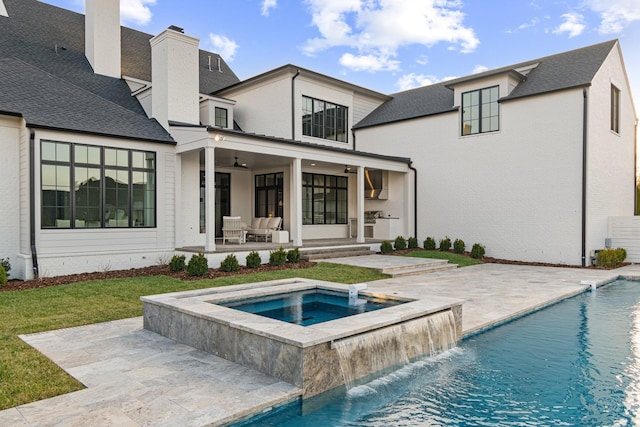 back of property featuring a swimming pool with hot tub, a patio area, pool water feature, and ceiling fan