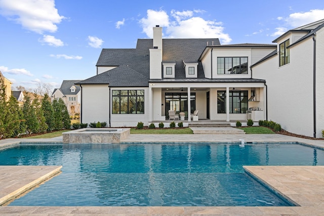 back of house featuring ceiling fan, a pool with hot tub, and a patio area