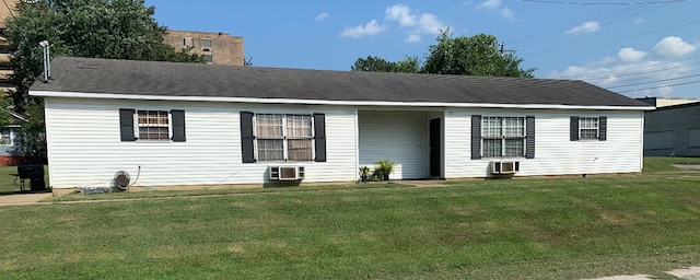 rear view of property with a lawn