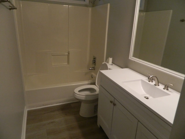 full bathroom with vanity, toilet, shower / washtub combination, and hardwood / wood-style floors