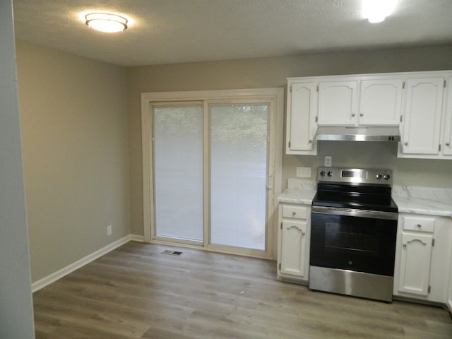 kitchen featuring white cabinetry, light wood-type flooring, and stainless steel electric range oven