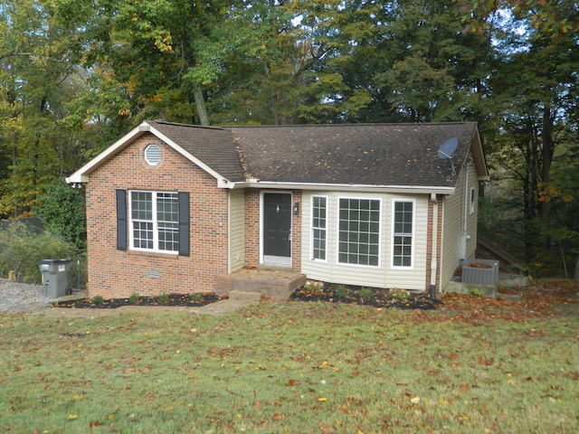 view of front of property featuring central AC and a front yard