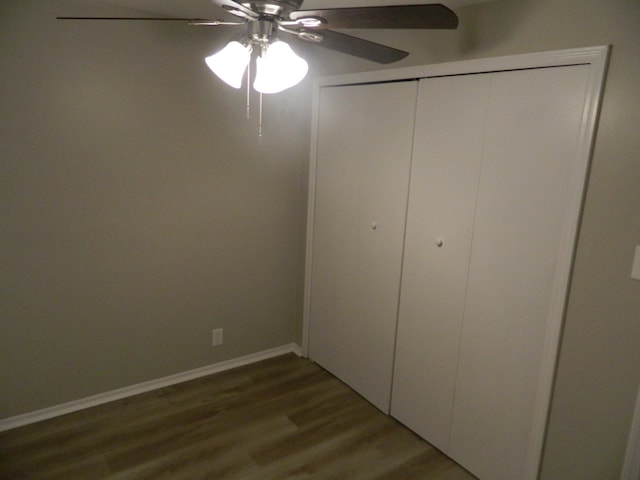 unfurnished bedroom featuring a closet, wood-type flooring, and ceiling fan