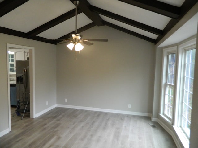 unfurnished room featuring vaulted ceiling with beams, light hardwood / wood-style flooring, and ceiling fan