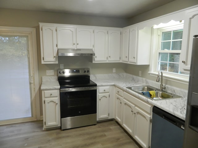 kitchen featuring white cabinets, stainless steel appliances, sink, and light wood-type flooring