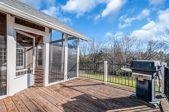 deck with area for grilling and a sunroom