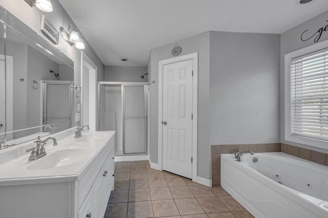 bathroom featuring tile patterned flooring, vanity, and shower with separate bathtub