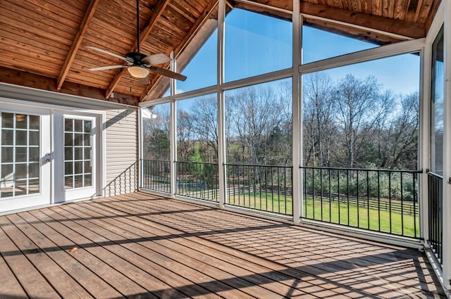 unfurnished sunroom featuring lofted ceiling with beams, a healthy amount of sunlight, wooden ceiling, and ceiling fan