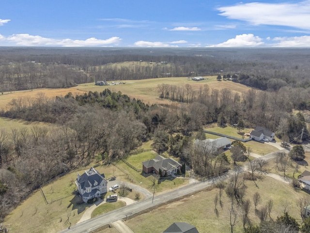 birds eye view of property featuring a rural view and a view of trees