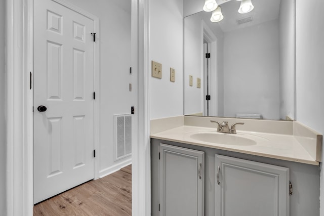 bathroom with vanity, hardwood / wood-style floors, and toilet