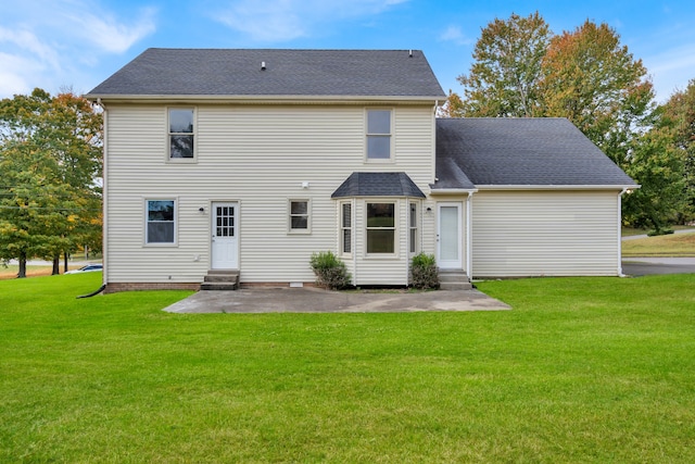 back of property featuring a yard and a patio area