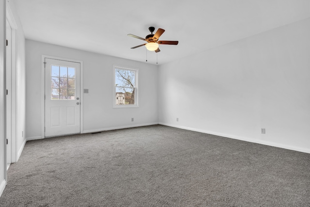 carpeted empty room featuring ceiling fan