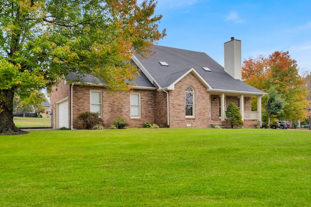 view of front of property featuring a front yard, a garage, and covered porch