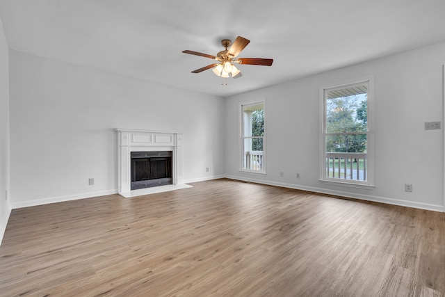 unfurnished living room with ceiling fan and light wood-type flooring