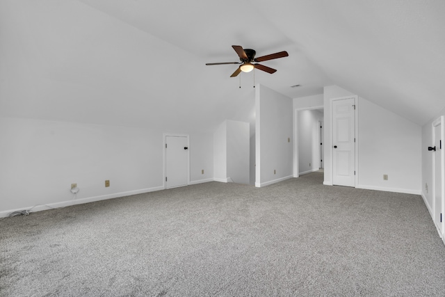 additional living space featuring carpet floors, ceiling fan, and vaulted ceiling