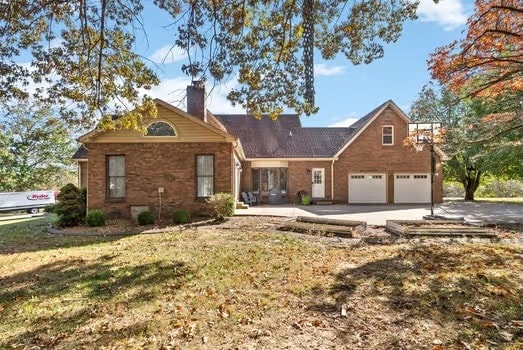 view of front of house with a front yard and a garage