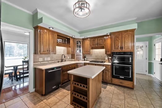 kitchen featuring black appliances, sink, plenty of natural light, and a kitchen island