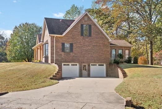 view of side of property featuring a yard and a garage