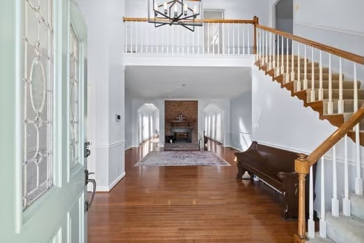 entryway featuring a notable chandelier, dark hardwood / wood-style floors, and a high ceiling