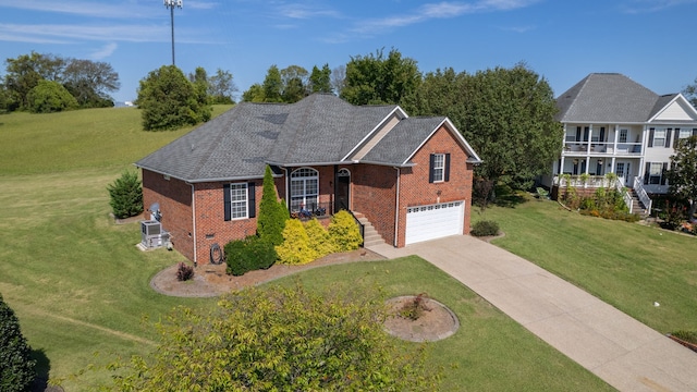 view of front of home with a front yard, a garage, and a balcony