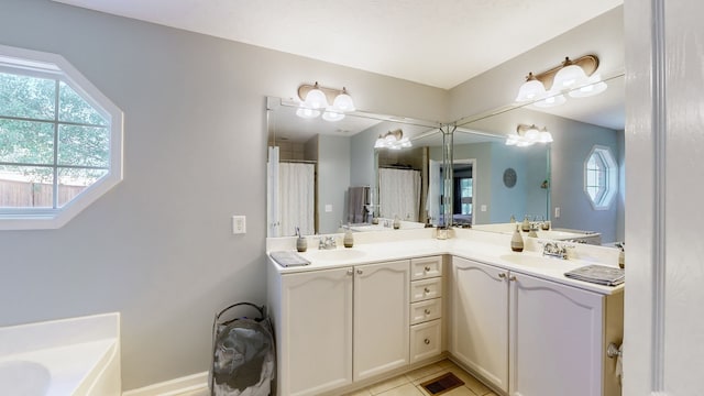 bathroom featuring vanity, a tub to relax in, and tile patterned flooring