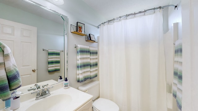 bathroom with vanity, toilet, and a shower with curtain