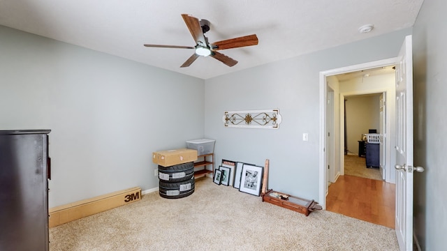 miscellaneous room featuring light colored carpet and ceiling fan