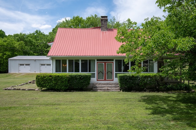 view of front of property with a front yard and a garage