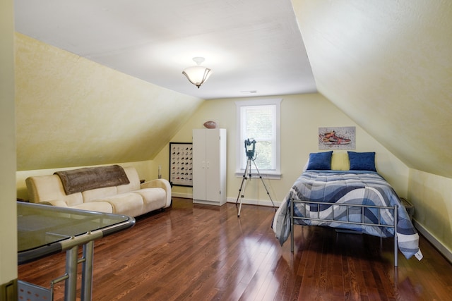 bedroom with lofted ceiling and wood-type flooring