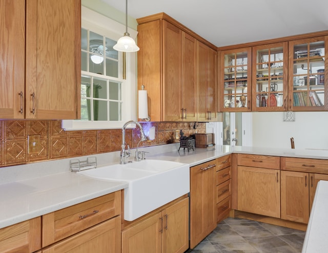 kitchen featuring decorative backsplash, sink, and pendant lighting