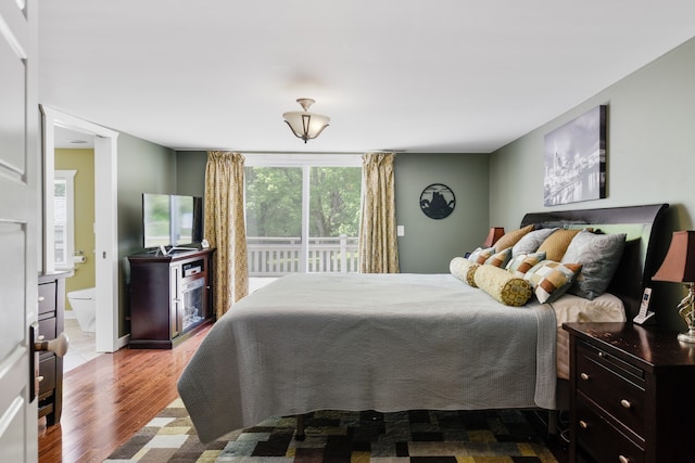 bedroom with light hardwood / wood-style flooring and ensuite bathroom