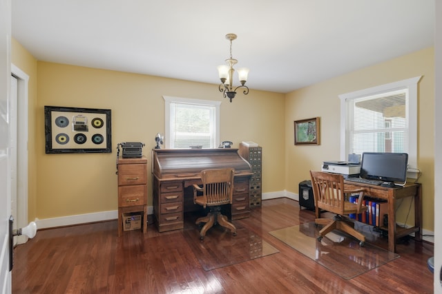 office space with dark wood-type flooring and a notable chandelier