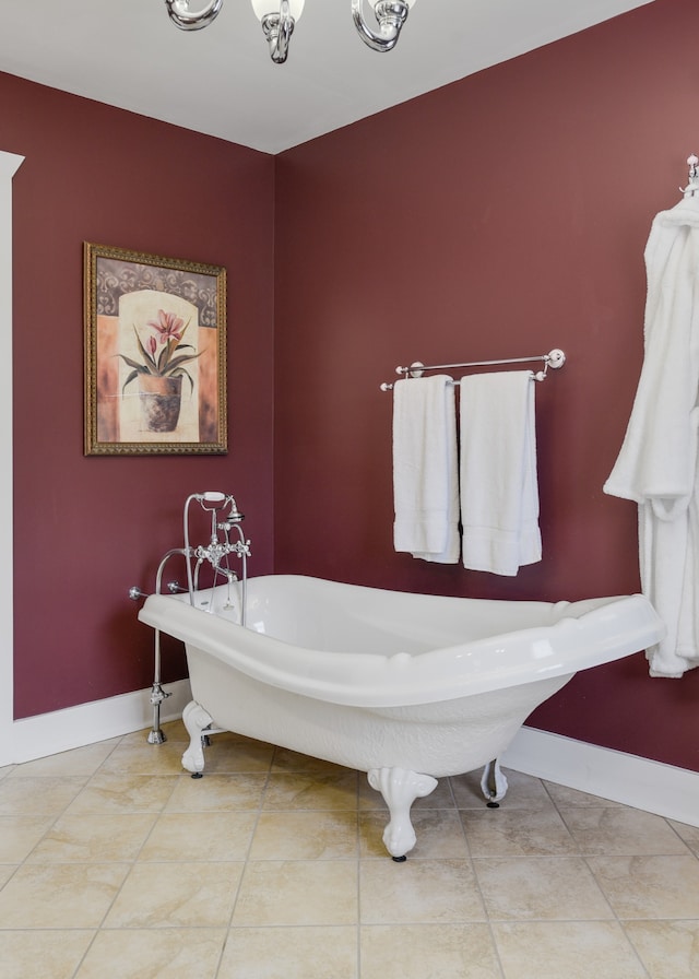 bathroom with a tub to relax in and tile patterned flooring