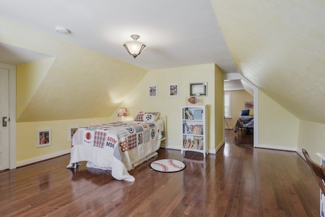 bedroom with vaulted ceiling and dark hardwood / wood-style flooring