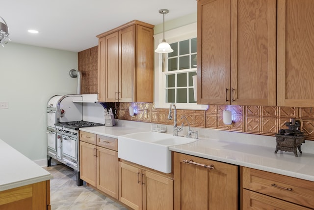 kitchen featuring decorative backsplash, sink, and decorative light fixtures