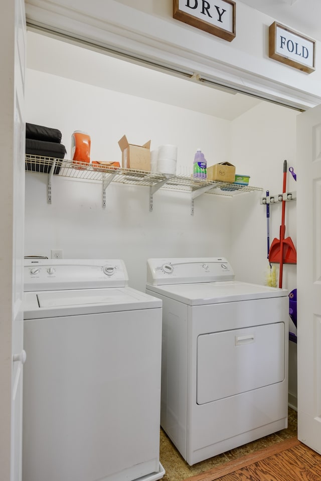 laundry area featuring light hardwood / wood-style flooring and washer and clothes dryer