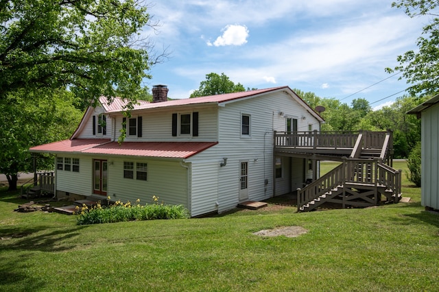 back of house featuring a yard and a deck