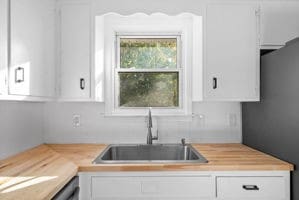 kitchen with white cabinetry and sink