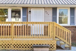 view of exterior entry with a wooden deck