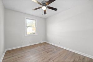 spare room featuring hardwood / wood-style floors and ceiling fan