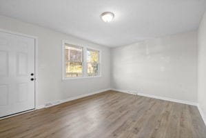 unfurnished room with hardwood / wood-style floors