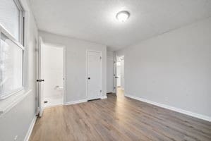 unfurnished bedroom with wood-type flooring